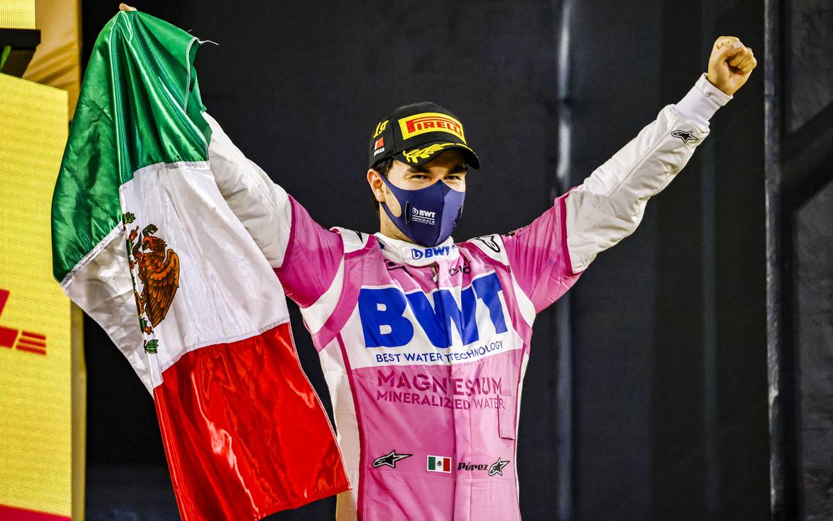 Sergio Perez, Racing Point, 1st position, with a Mexican flag on the podium